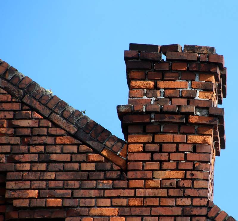 Damaged chimney on an Richardson home showing cracks and missing mortar